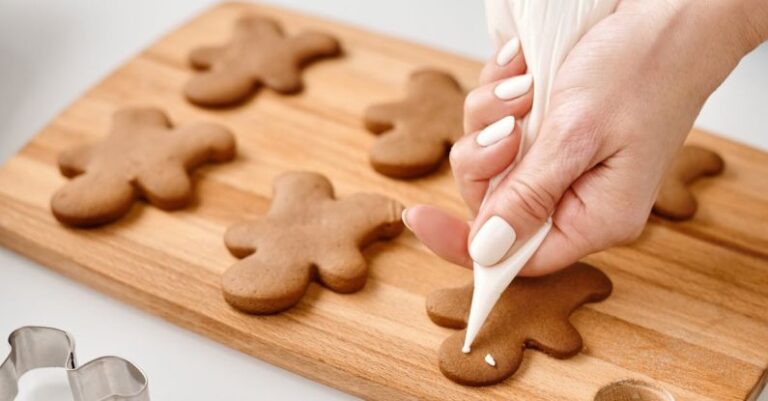 Kitchen Art - Person Decorating a Gingerbread Man Cookies