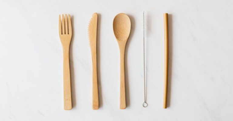 Kitchen Accessories - Wooden cutlery and tube with brush on marble table