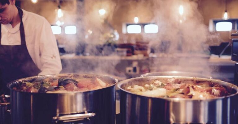 Industrial Kitchen - Man Wearing Black Apron Near Two Silver Metal Cooking Pot