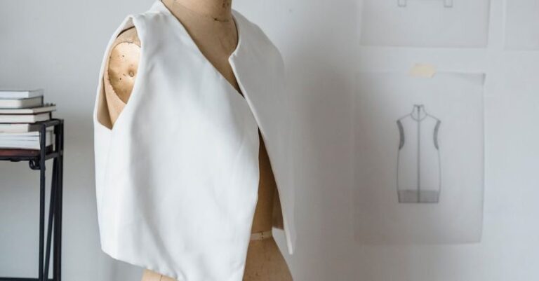 Colorful Appliances - Mannequin in white vest at white wall with drafts of clothes in light room of modern atelier with books