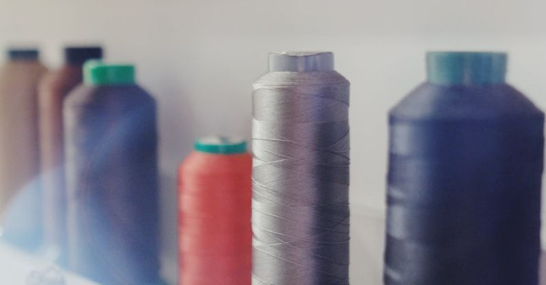 Shelf Materials - Spool of Threads and Hanging Metal Bobbins on Shelves