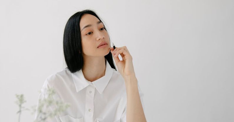 Minimalist Look - Thoughtful Asian employee with agendas at office table