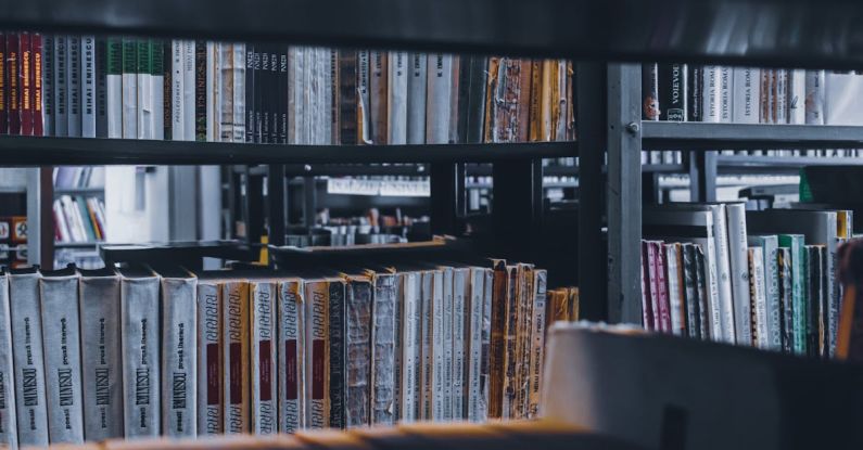 Smart Storage - Stacks of various books placed in row on shelf in university library in daylight