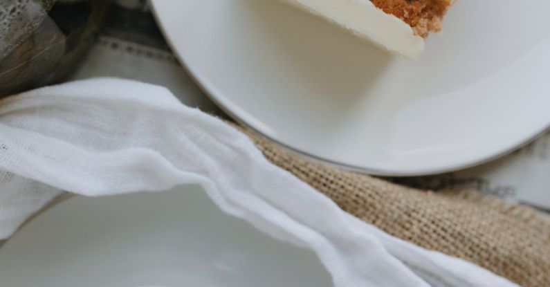 Layered Lighting - A white plate with a piece of cake and a cup of tea